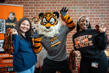 students with powercat holding pompoms